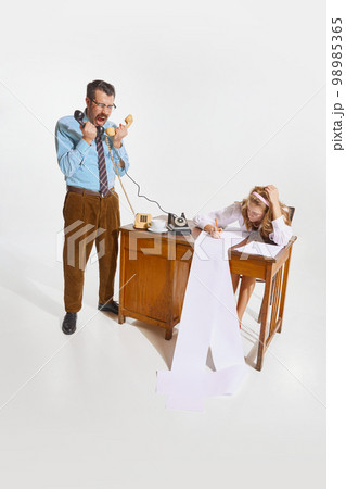 Businessman making ideas, giving information and woman, personal assistant making notes over grey background. Concept of business, employment, work 98985365