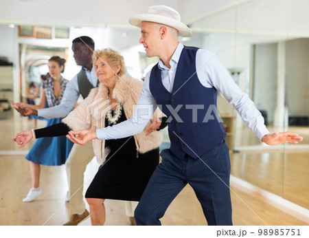 Jazz dancers standing in row and flicking with fingers Jazz dancers standing in row and flicking with fingers 98985751