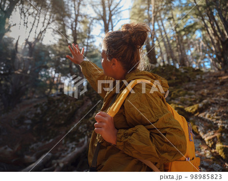 caucasian woman enjoys being in nature, 98985823