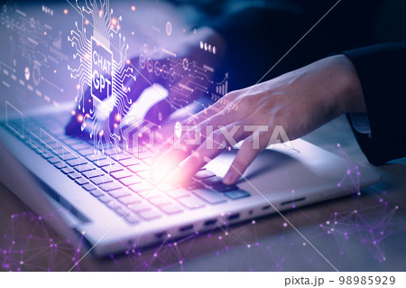 ChatGPT chatting with artificial intelligence or AI. Businessman using notebook (laptop) with chatbot by OpenAI. Futuristic technology concept. 98985929
