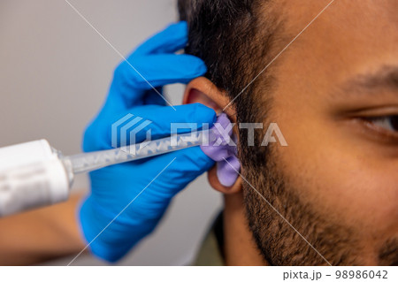 ENT doctor examining the patient with the medical apparatus ENT doctor examining the patient with the medical apparatus 98986042