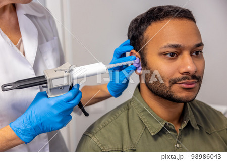 ENT doctor examining the patient with the medical apparatus ENT doctor examining the patient with the medical apparatus 98986043