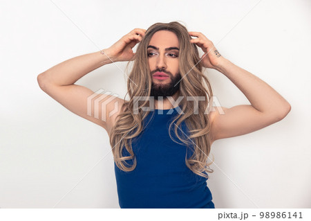 Travesty man fixing his fake long hair 98986141
