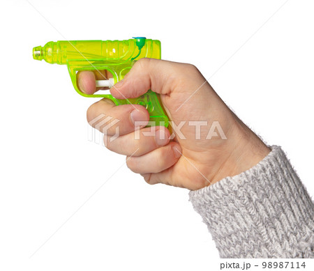 Hand holding plastic watergun toy 98987114
