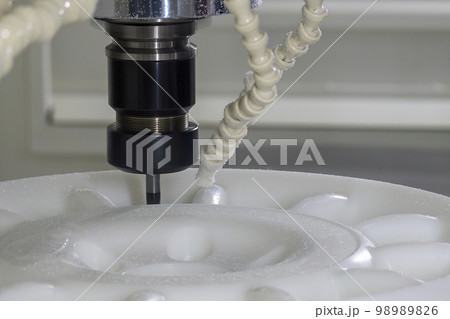 The  CNC milling machine cutting the nylon 6 material part with ball end mill tool. 98989826