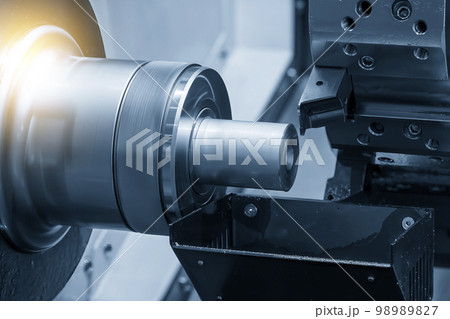 The  CNC lathe machine forming  cutting the metal shaft parts. 98989827