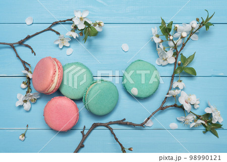 Dessert macaroons on a blue wooden background Dessert macaroons on a blue wooden background 98990121