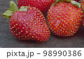 Ripe strawberries on a wooden board 98990386
