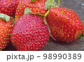 Ripe strawberries on a wooden board 98990389