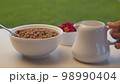 Bowl of cornflakes and raspberry 98990404
