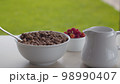 Bowl of cornflakes and raspberry 98990407