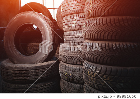 stack of car wheel tires at modern warehouse 98991650
