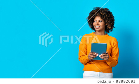 Positive african lady holding digital tablet, copy space 98992093