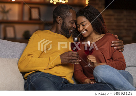Loving black husband hugging his pretty wife, home interior 98992125