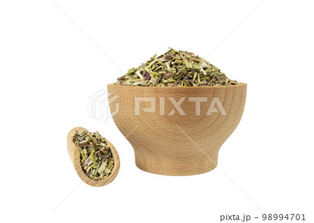Catnip herb in latin - Nepeta cataria in wooden bowl and scoop isolated on white background. Medicinal herb. 98994701
