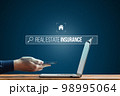 Person works on smartphone and laptop. Looking for insurance on the Internet for real estate. Risk of an earthquake. 98995064