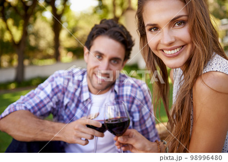 Happy couple, portrait or wine toast for love picnic, valentines day or romance date bonding in nature park or garden. Smile, woman or man and alcohol drinks glass in marriage anniversary celebration 98996480