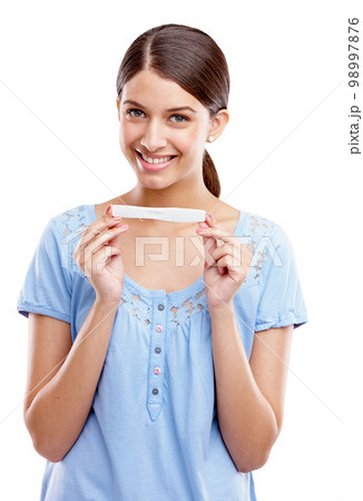 Happy, portrait and pregnant test of woman with excited face for motherhood, maternity and future baby. Happiness of girl holding pregnancy test with smile on isolated white background. 98997876