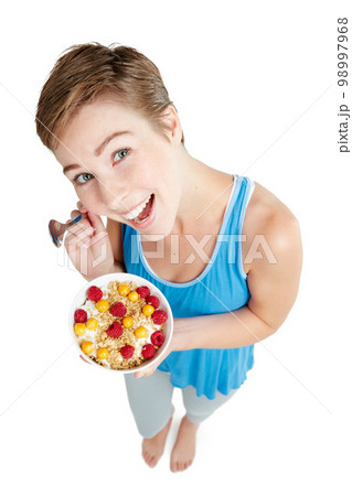 Portrait, breakfast and food with a woman in studio isolated on a white background for health from above. Diet, muesli and overhead with an attractive young female eating healthy for nutrition Portrait, breakfast and food with a woman in studio isolated on a white background for health from above. Diet, muesli and overhead with an attractive young female eating healthy for nutrition 98997968