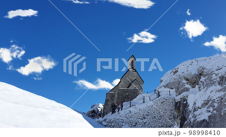 small old church on mountain. Beautiful alpine mountains in winter. Bayrischzell, Bavaria, Germany. 98998410