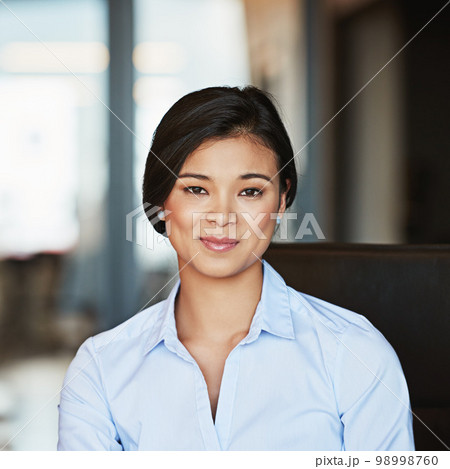 Portrait, young and Asian business woman working in a modern office and smiling. Happy, confident and female entrepreneur or insurance professional in Bangkok on a webcam at a company Portrait, young and Asian business woman working in a modern office and smiling. Happy, confident and female entrepreneur or insurance professional in Bangkok on a webcam at a company 98998760