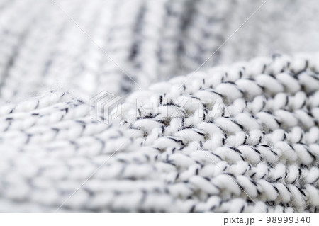 Texture of the fabric of a winter sweater Texture of the fabric of a winter sweater 98999340