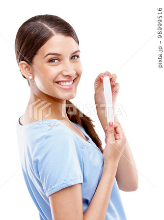 Pregnancy test, happy and portrait of a woman in a studio with good, exciting and positive news. Happiness, smile and young female model with a prenatal urine kit isolated by a white background. 98999516