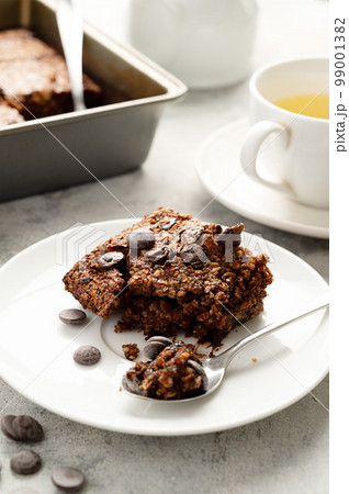 Slice of brownies with chocolate chips and rolled oats. Homemade healthy dessert. Slice of brownies with chocolate chips and rolled oats. Homemade healthy dessert. 99001382