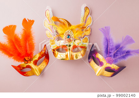 Venetian mask, Carnival mask for Mardi Gras celebration isolated on purple background banner design with copy space, jewish holiday, Purim in Hebrew holiday carnival ball, Happy Purim carnival concept Venetian mask, Carnival mask for Mardi Gras celebration isolated on purple background banner design with copy space, jewish holiday, Purim in Hebrew holiday carnival ball, Happy Purim carnival concept 99002140