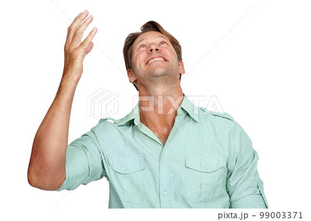 Thank you, happy and man in studio, smile and celebrating victory while looking up on white background. Hand, success and young male in prayer for successful, winner or achievement while isolated 99003371