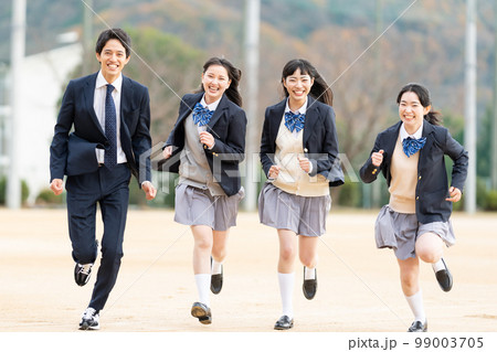 校庭を走る女子高生と男子学生 99003705