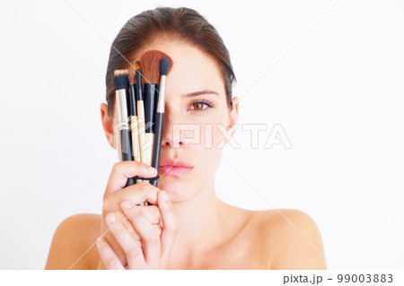 Woman, face and makeup tools in portrait, beauty and cosmetics isolated on white background. Mockup space, female in studio with cosmetic brush in hands and skincare, dermatology glow and wellness 99003883