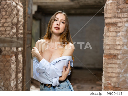 Sensual woman undressing in deserted building 99004154