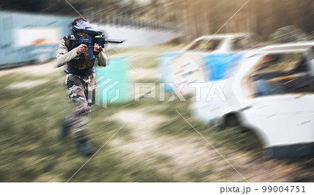 Paintball, gun or man running in a shooting game with fast action on a fun battlefield on holiday. Military mission, fitness or player with speed, weapons gear for survival in an outdoor competition Paintball, gun or man running in a shooting game with fast action on a fun battlefield on holiday. Military mission, fitness or player with speed, weapons gear for survival in an outdoor competition 99004751