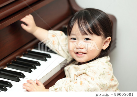 アップライトピアノを弾く1歳の女の子 99005081