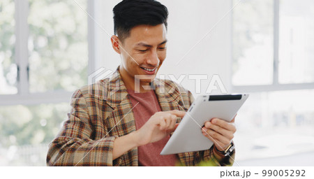 Tablet, research and creative with an asian man designer thinking about an idea while working on a design. Internet, innovation and search with a male employee at work in his marketing office 99005292