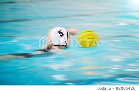 Sports, water polo and athlete swimming with a ball for a competition, exercise or hobby. Fitness, blur motion and swimmer training to play a professional sport game or match in a indoor pool. 99005420