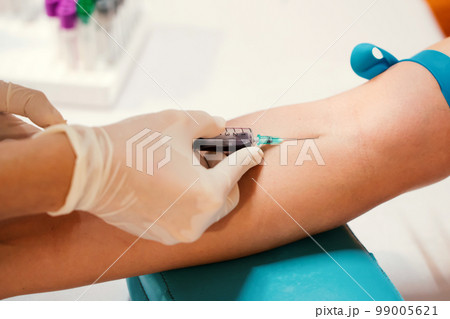 Nurse collecting a blood from patient in hospital 99005621