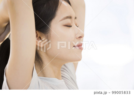 トレーニングジムでストレッチをする若い女性 トレーニングジムでストレッチをする若い女性 99005833