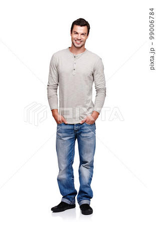 Portrait, smile and man with hands in pocket in studio isolated on a white background looking happy. Pride, cool and model male posing in denim jeans clothes for trendy style and positive mindset 99006784