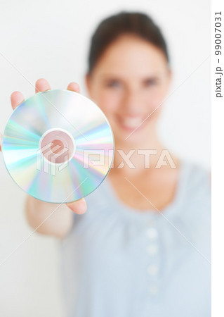 Vintage, music and hand of woman with cd in studio showing nostalgic, fun and old fashioned entertainment with mockup. Hands, dvd and girl presenting shiny disc, copy space and isolated mock up 99007031