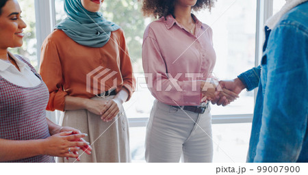 Teamwork, business people and handshake for partnership, collaboration or deal in office meeting. Thank you, welcome and group of employees shaking hands for agreement, greeting or hiring contract. 99007900