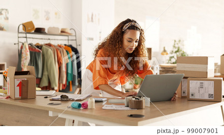 Logistics, laptop and fashion manager of retail or boutique shop checking clothing stock in boxes on a checklist. Small business, entrepreneur and young woman working with clothes inventory in store 99007901