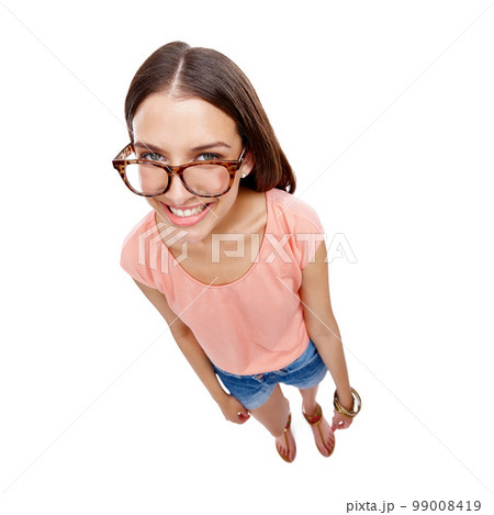 Woman, happy and portrait of a model with glasses, smile and casual fashion. White background, happiness and isolated young person looking up with eyewear in a studio feeling positive and calm 99008419
