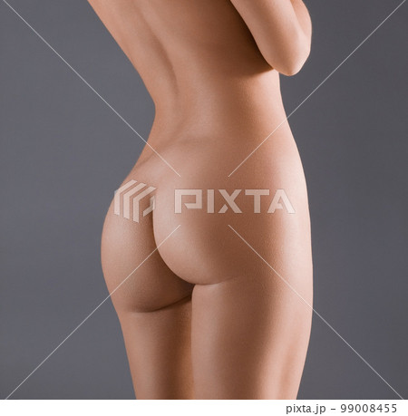 Woman, butt and body in studio for beauty, grooming and self care on a grey background. Model, buttocks and girl relax with skincare, wellness and naked, sexy and desire while posing nude isolated 99008455