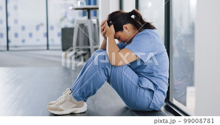 Healthcare, stress and sad nurse on floor with burnout, anxiety and headache working in emergency services. Medical care, mental health and health care worker with depression in hospital or clinic Healthcare, stress and sad nurse on floor with burnout, anxiety and headache working in emergency services. Medical care, mental health and health care worker with depression in hospital or clinic 99008781
