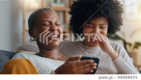 Women, laugh and phone search on dating app profile, internet movie streaming and social media in house living room. Happy smile, comic friends bond or lgbtq black couple on web in home interior sofa Women, laugh and phone search on dating app profile, internet movie streaming and social media in house living room. Happy smile, comic friends bond or lgbtq black couple on web in home interior sofa 99008935