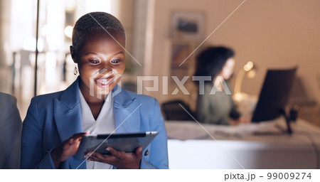 Business, night and black woman working on tablet in corporate office. Technology, internet and businesswoman doing overtime at work, busy with deadline. Online, tech and girl using digital notebook 99009274