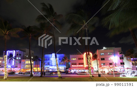 Night vibes at Ocean Drive, Art Deco Historic District in Miami Beach with illuminated hotels  99011591