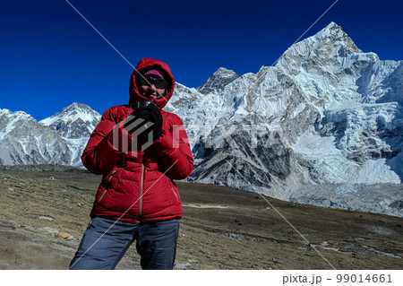 Hiker woman posing with mountains at background Hiker woman posing with mountains at background 99014661